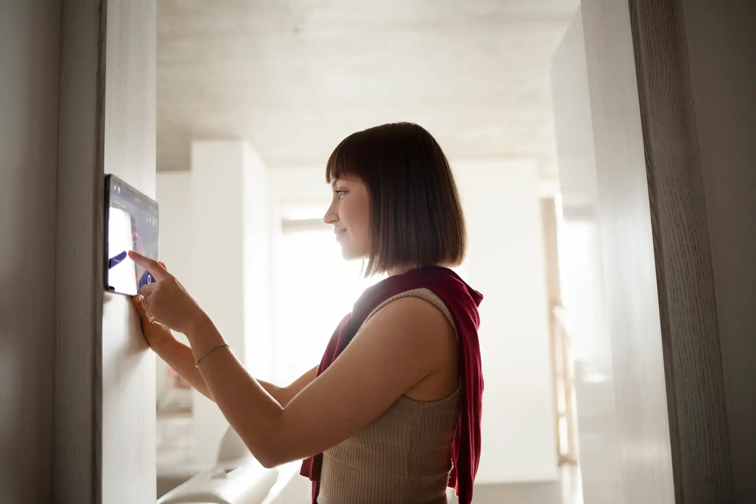 Woman using a wireless intercom system in her home